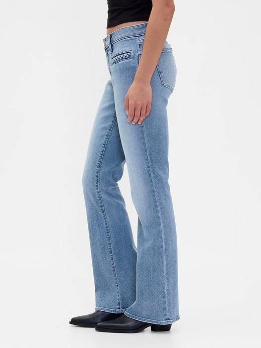 jeans lunghi e attillati con tasche intrecciate a vita bassa