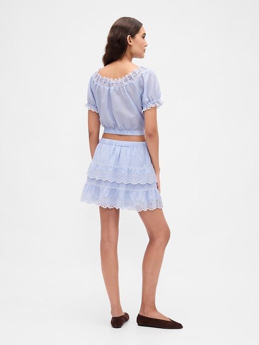 mini gonna-pantalone con volant e occhielli