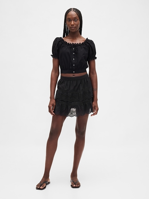 mini gonna-pantalone con volant e occhielli