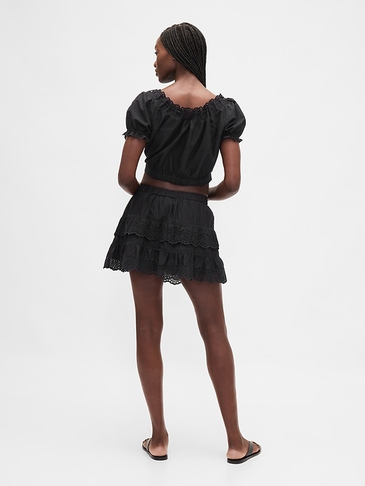mini gonna-pantalone con volant e occhielli