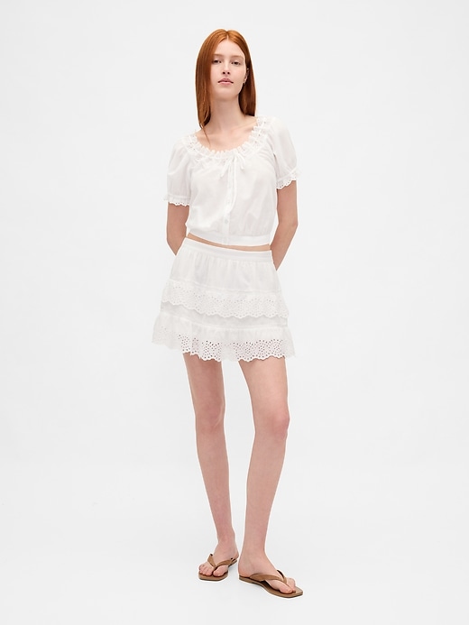 mini gonna-pantalone con volant e occhielli