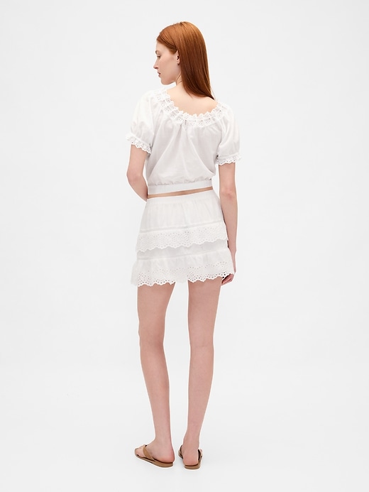 mini gonna-pantalone con volant e occhielli