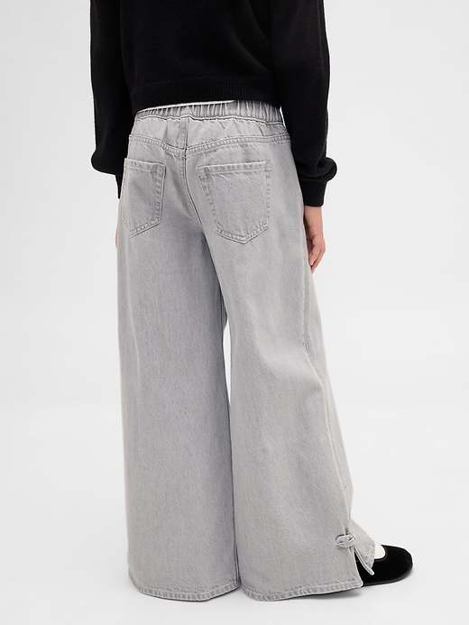 jeans larghi con orlo diviso e fiocco a vita bassa per bambini